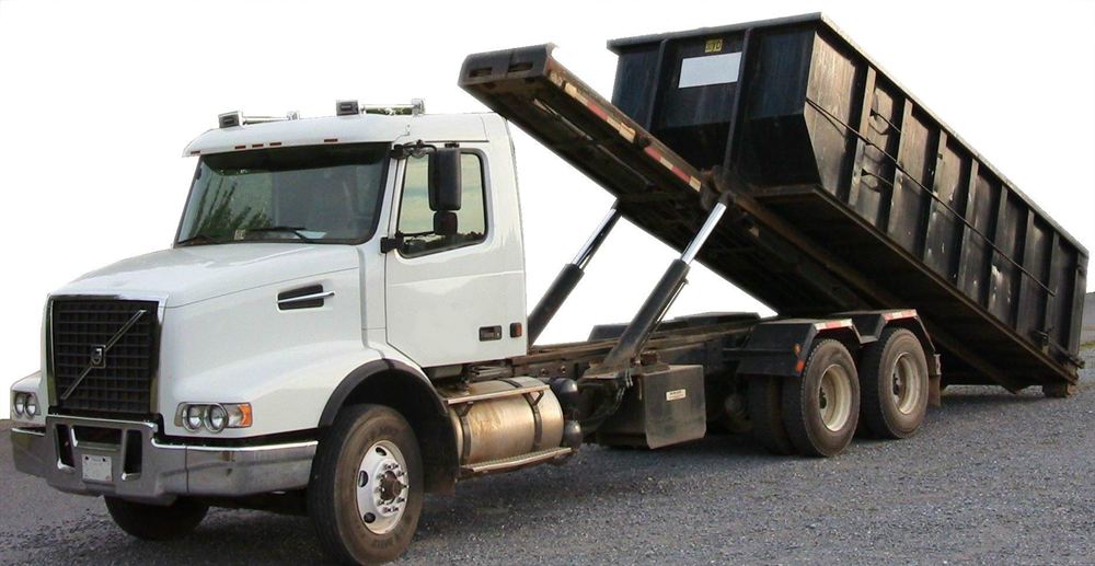 Waste & Haul roll-off truck delivering a dumpster